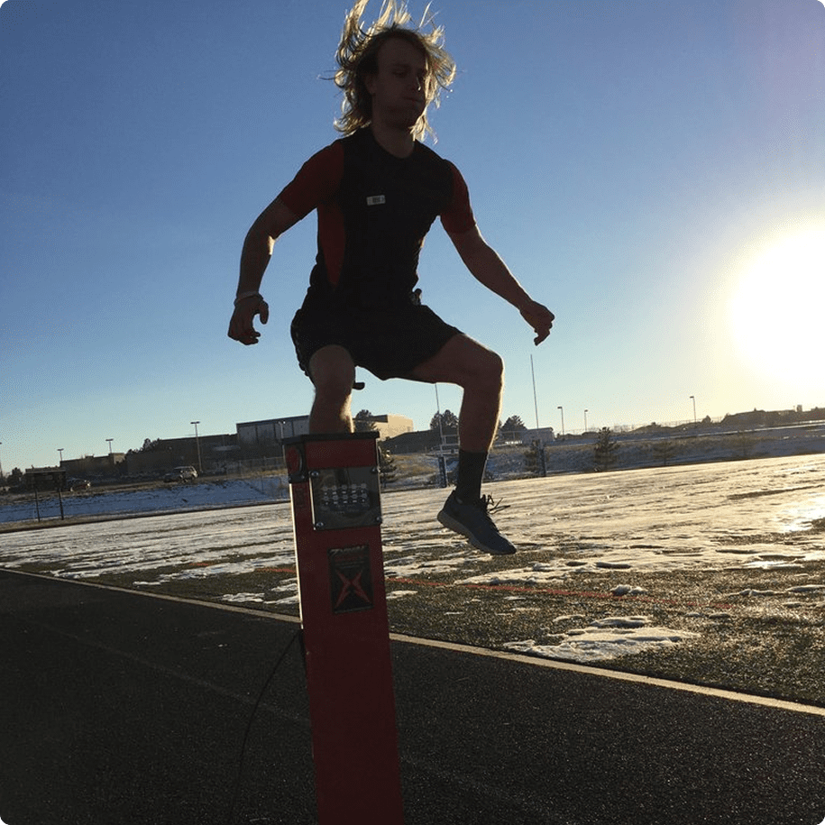 Athlete jumping over a tall hurdle.