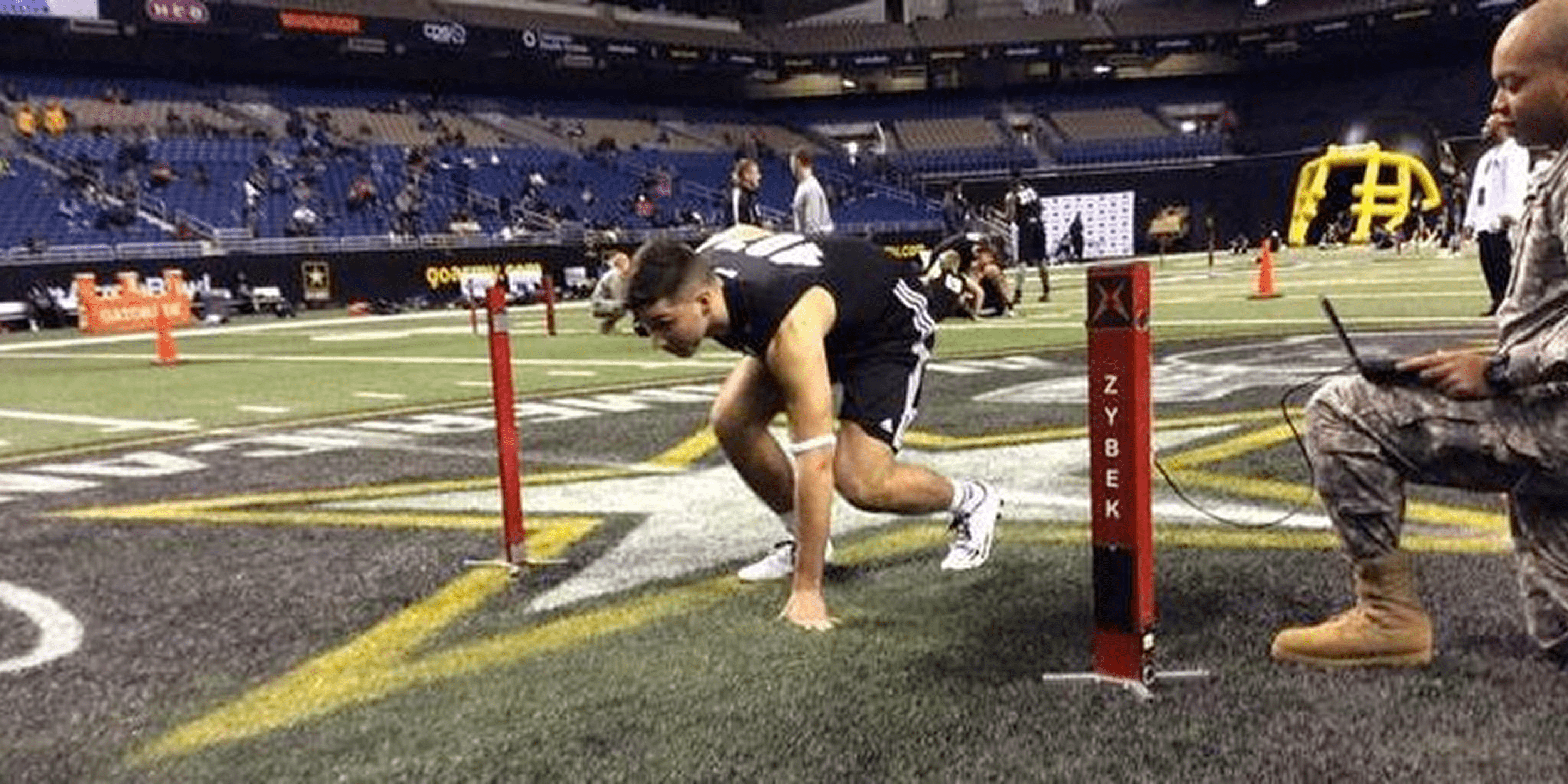 A man is running on the field with poles.