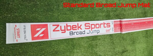 Broad jump mat on green grass surface.