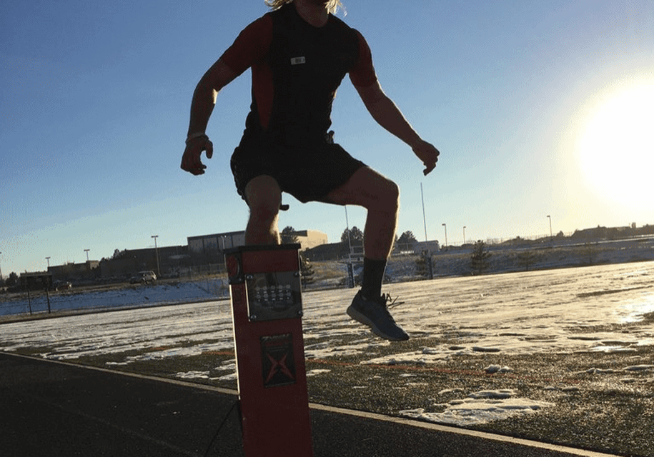Athlete jumping over a tall hurdle.